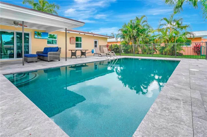 View of swimming pool with a patio area and ceiling fan