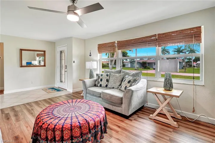 Living room featuring light hardwood / wood-style flooring, a wealth of natural light, and ceiling fan