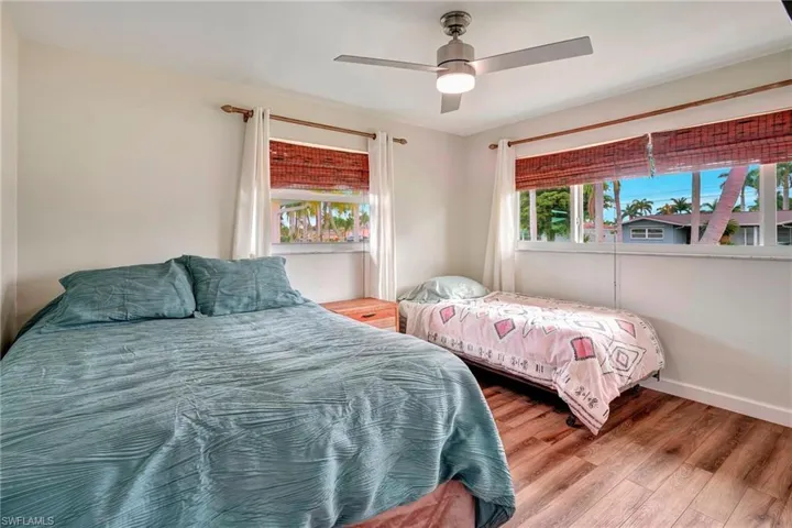 Bedroom with hardwood / wood-style flooring and ceiling fan
