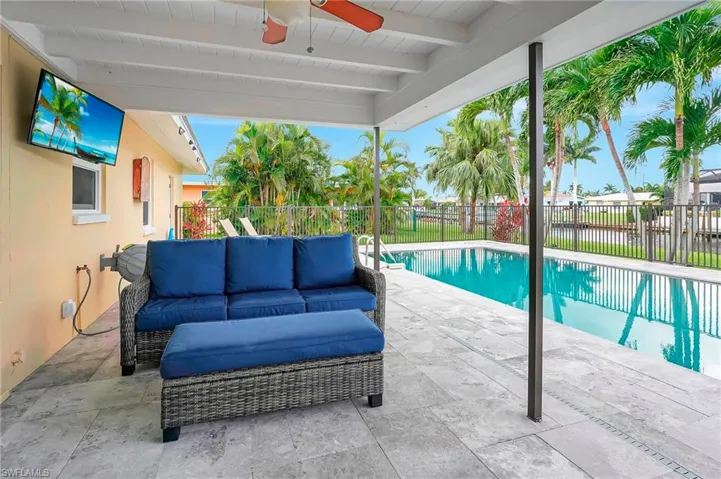 View of pool featuring an outdoor living space, ceiling fan, and a patio area