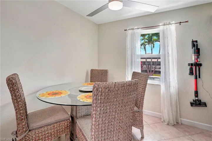 Tiled dining space featuring ceiling fan