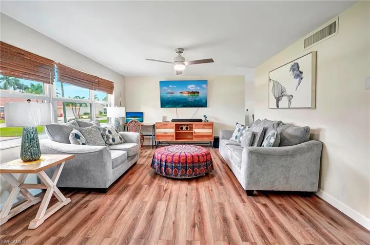 Living room with ceiling fan and wood-type flooring