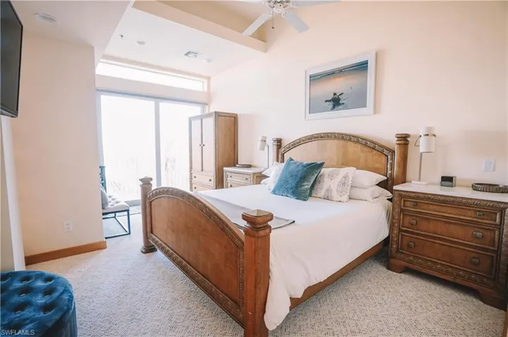 Carpeted bedroom featuring ceiling fan