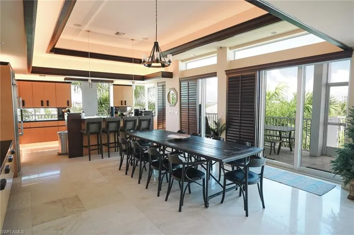 Dining room with an inviting chandelier and a tray ceiling