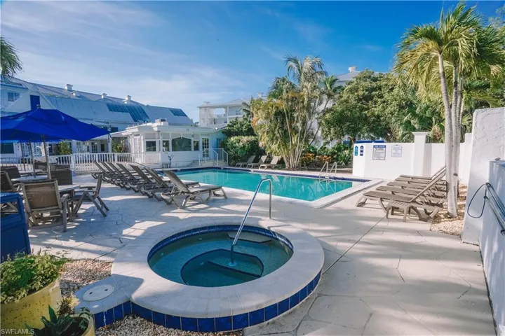 View of swimming pool featuring a community hot tub and a patio