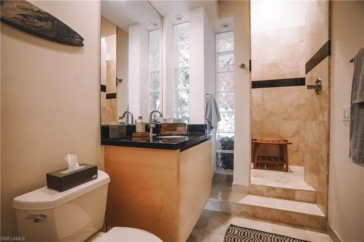 Bathroom featuring tile patterned flooring, vanity, and toilet
