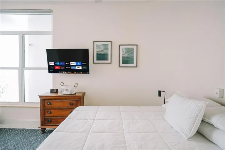 Bedroom featuring light carpet