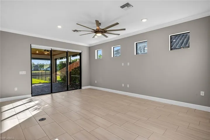 Living room with a ceiling fan, crown molding, and recessed lighting