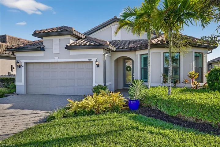 Mediterranean / spanish house with stucco siding, decorative driveway, an attached garage, and a tiled roof
