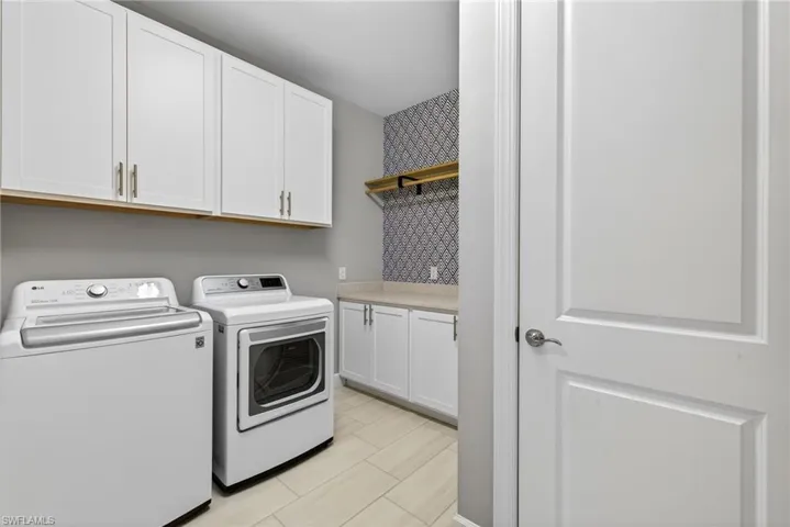 Laundry room with washing machine and dryer and cabinet space