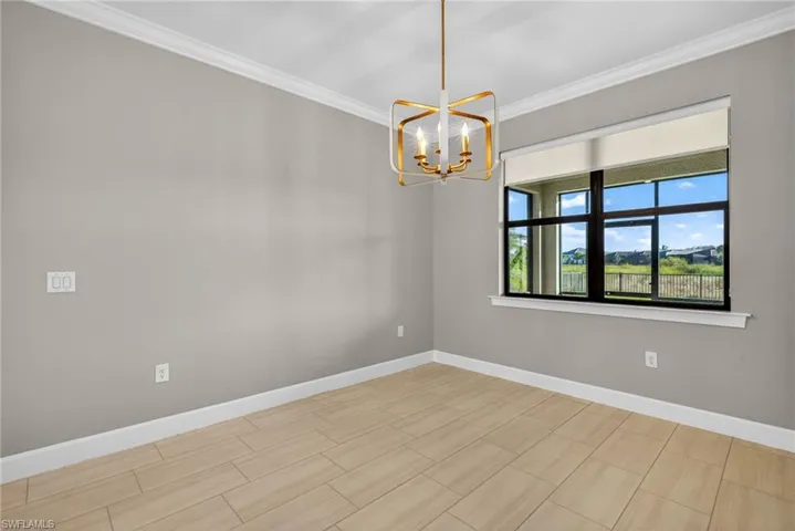 Dining room featuring a chandelier, crown molding, and wood tiled floors