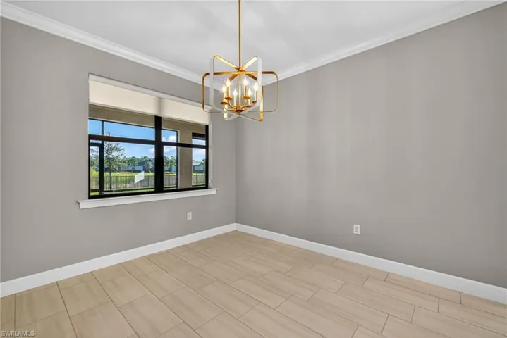 Dining room with a chandelier, crown molding, and wood tiled floors