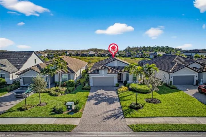 Ranch-style house featuring a residential view, decorative driveway, a front yard, an attached garage, and stucco siding