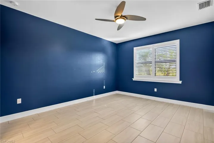 Bedroom with ceiling fan and wood finish floors