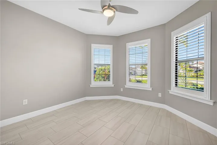 Empty room featuring a ceiling fan and wood finish floors