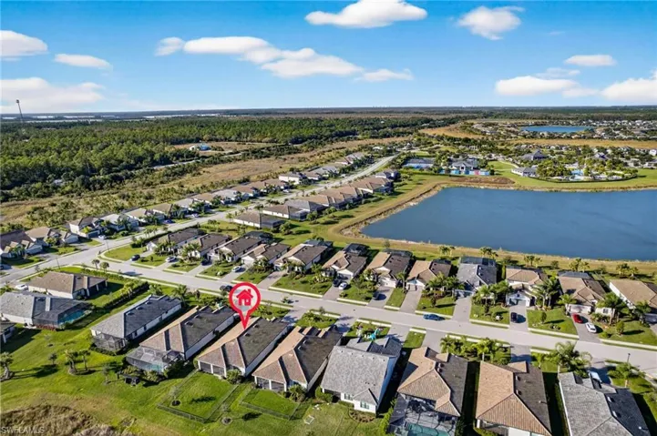 Aerial overview of property's location with nearby suburban area and a large body of water