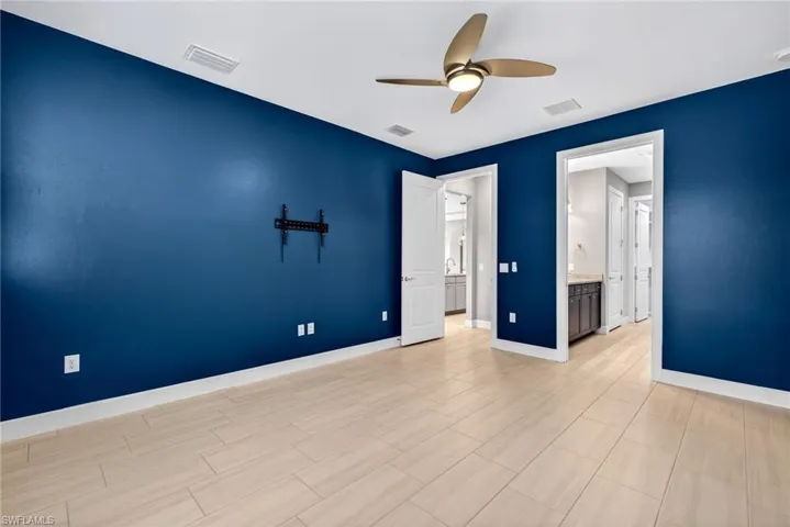 Bedroom with a ceiling fan and baseboards