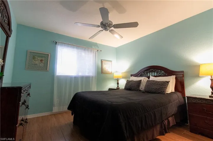 Bedroom featuring light hardwood / wood-style floors and ceiling fan