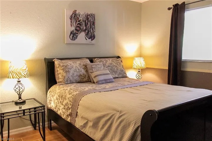 Bedroom with hardwood / wood-style flooring
