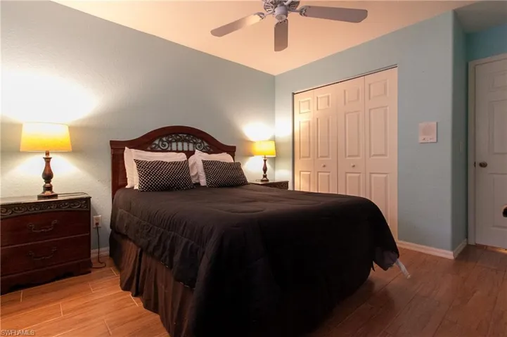Bedroom featuring light hardwood / wood-style flooring, a closet, and ceiling fan