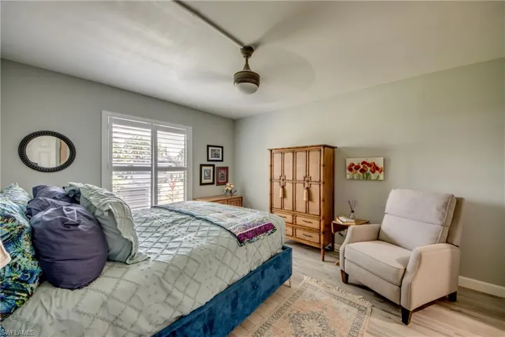 Bedroom with hardwood / wood-style floors and ceiling fan