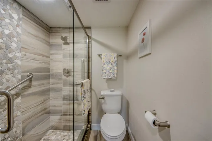 Bathroom with an enclosed shower and toilet