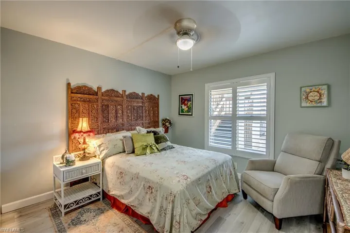 Bedroom with ceiling fan and hardwood / wood-style floors