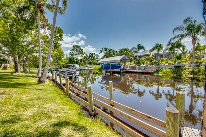 Dock area featuring a water view and a yard