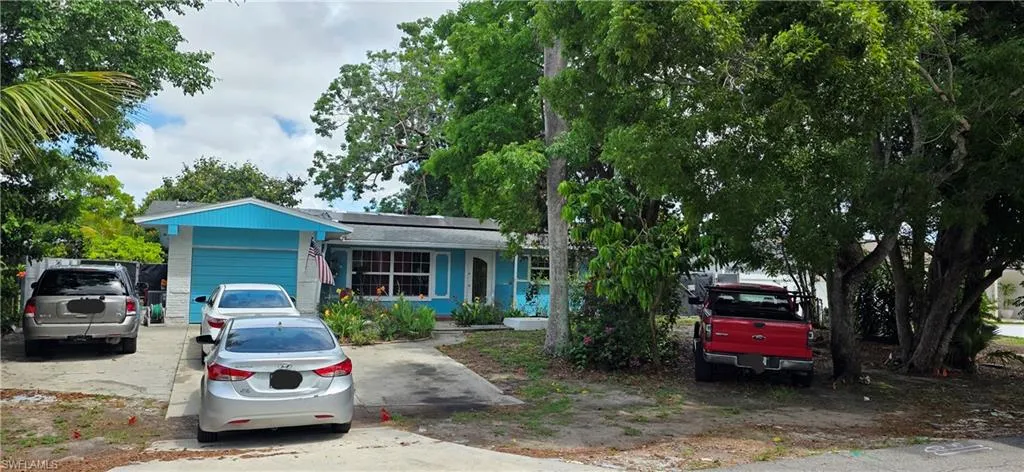 View of front of property featuring roof mounted solar panels