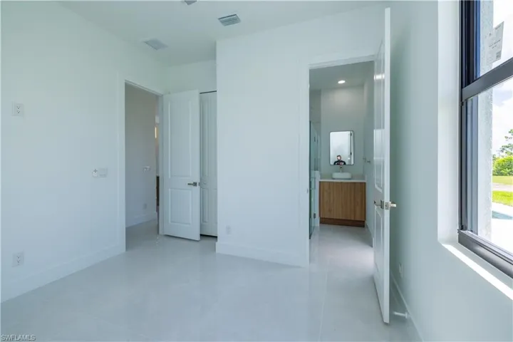 Unfurnished bedroom featuring light tile floors