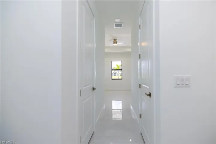 Hallway with tile flooring
