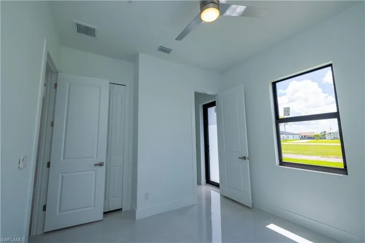 Unfurnished bedroom featuring ceiling fan, a closet, and light tile flooring