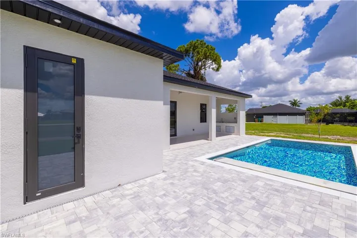 View of pool with a yard and a patio area