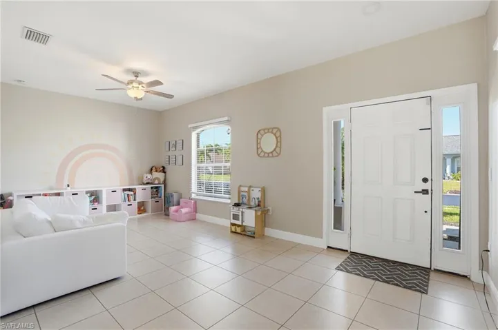 This is a flex space, it can be used as a dinning room or a playroom as shown.