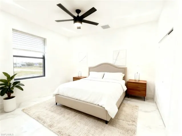 Bedroom with ceiling fan and a closet