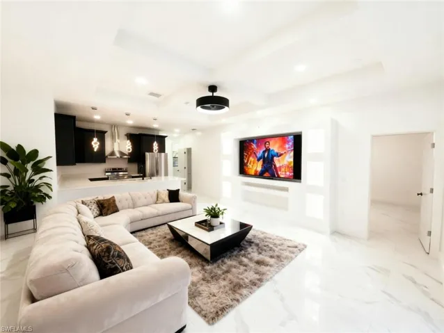 Living room with recessed lighting, coffered ceiling, and light marble finish floors