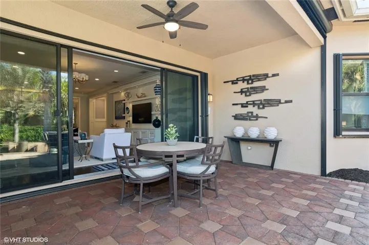 Covered lanai with easy-close accordian hurricane shutters, and electric retractable hurricane screen