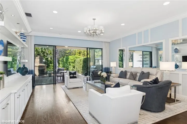 Open Great room with built-it, crown molding, and custom trim work