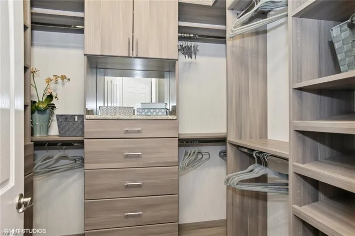 2 primary suite closets, both with custom built-is in