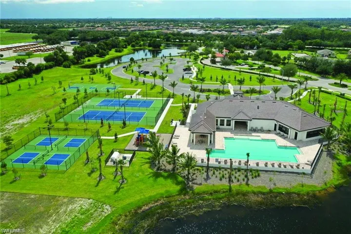 Community clubhouse featuring an expansive swimming pool and surrounding paved deck