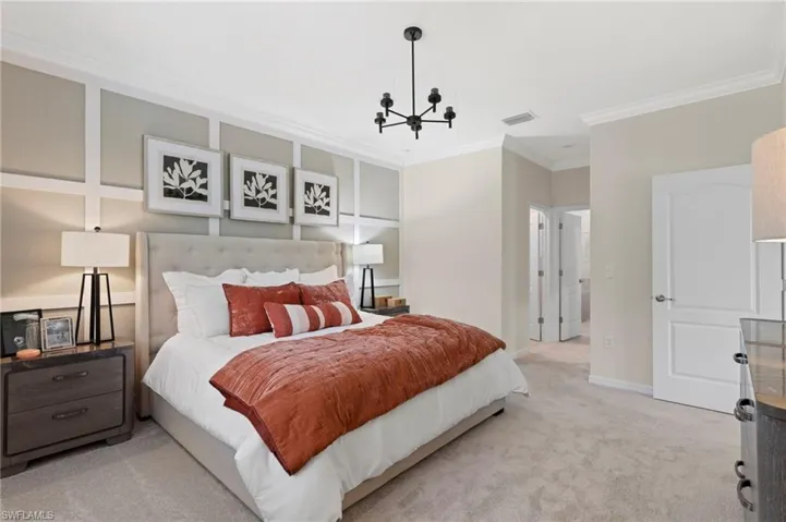 Spacious interior featuring detailed wall paneling, crown molding, and plush carpeting