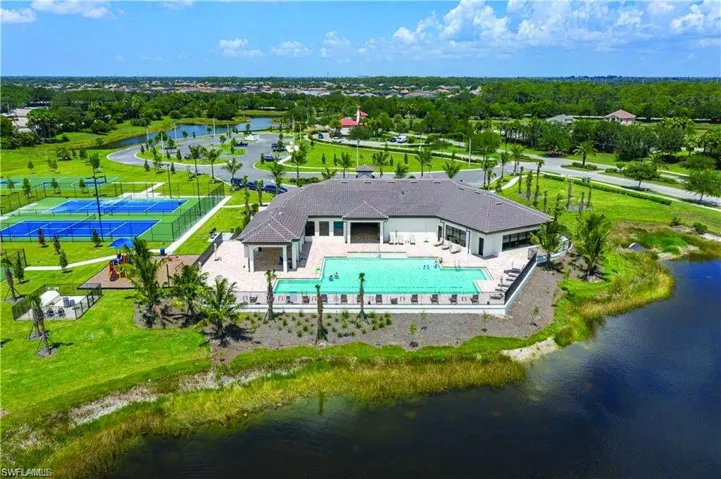 Community amenity center featuring a resort-style swimming pool with sun deck, tennis courts, and playground