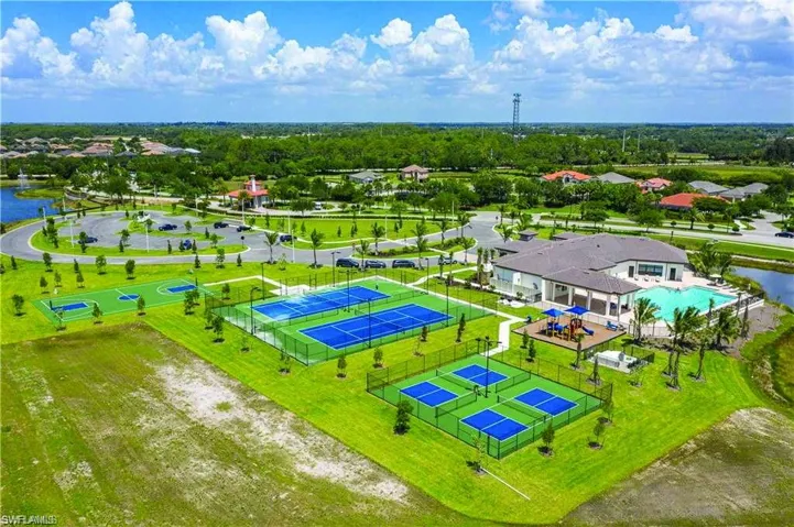 Expansive recreational area featuring multiple sports courts, a swimming pool, and a clubhouse