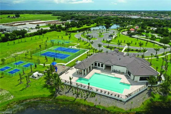 Clubhouse building featuring a tile roof and an outdoor pool