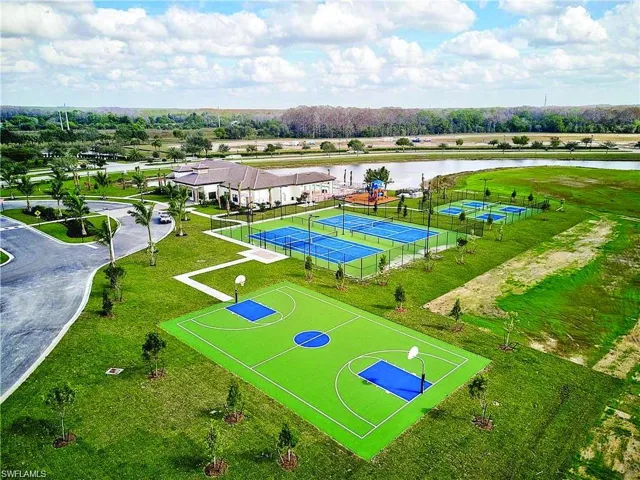 Amenities area featuring a basketball court, multiple tennis courts, and a community building with a covered patio