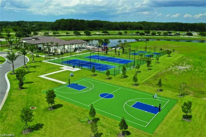 Community recreation area featuring a full-size basketball court, multiple tennis courts, and a clubhouse