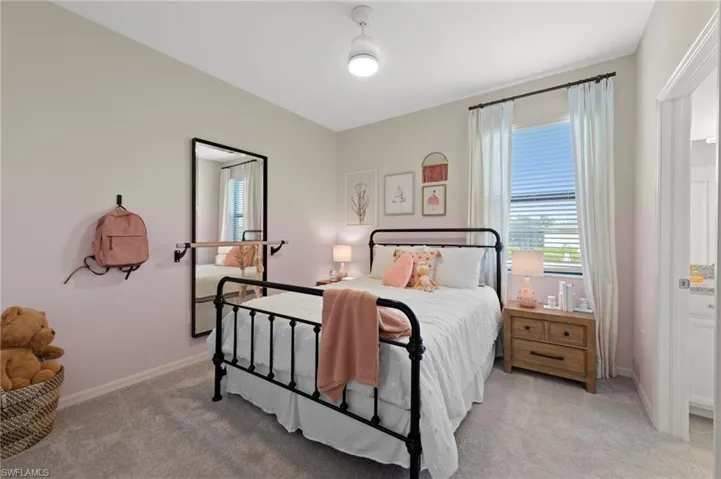 Bedroom featuring carpet flooring, a ceiling fan with integrated lighting, a window with blinds, and white trim