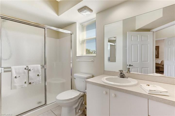 Main bath with glass doors, tub and shower combination.