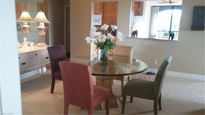 Dining space with carpet floors and baseboards