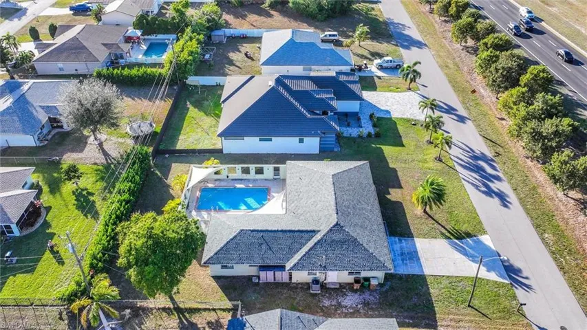 Aerial view of residential area featuring a pool area